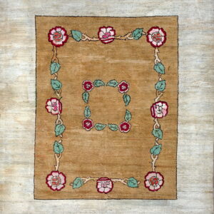 Golden brown rug featuring two rectangular borders of stylized pink roses and pale green leaves.