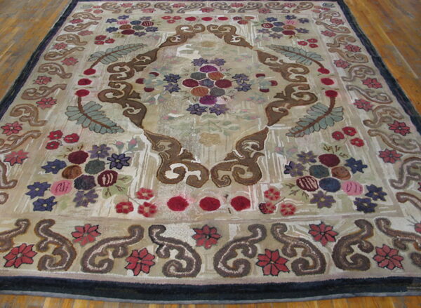 Sculpted, high-pile rug with a beige field, brown medallion, and multi-colored floral border on hardwood flooring.