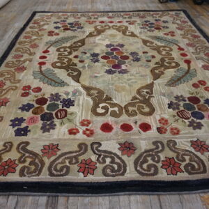 Low-pile rug with colorful floral and brown scroll design on a light beige background over wood floor.