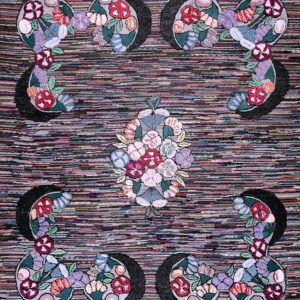 Striped multicolor rug with symmetrical floral motifs featuring blooms of red, purple, pink, and green.