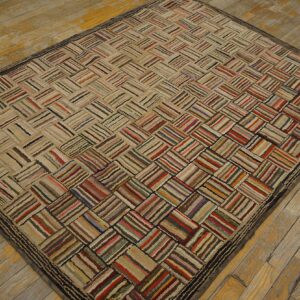 Textured rug with multicolored stripes forming a basketweave pattern rests on distressed wood flooring.