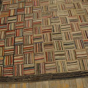 Textured multicolor striped block rug with a dark border resting on light brown wood flooring.