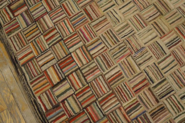 A multi-colored strip rug with a shaggy texture and a basketweave lattice pattern on light wooden floors.