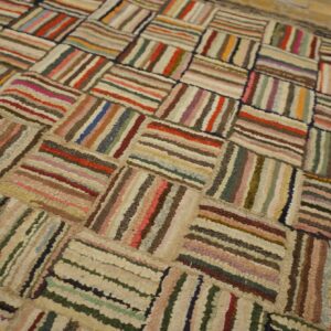 Textured, multicolor rug featuring striped rectangular blocks arranged in a basketweave pattern.