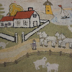 Hooked rug close-up featuring a scenic pattern with a red-roofed house, horses, and sheep on green and yellow ground.