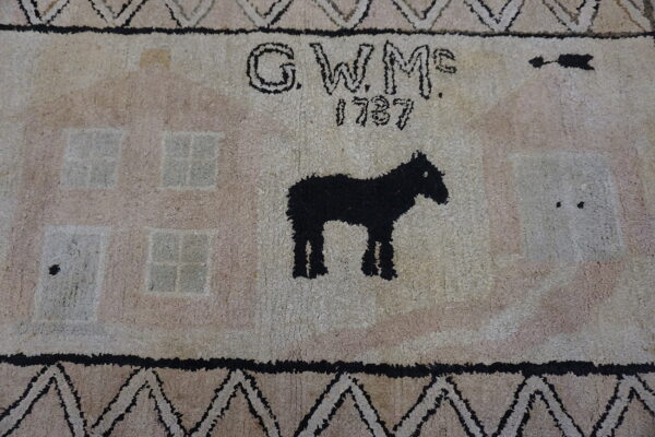 High-pile rug featuring a black horse, stylized pale houses, the initials g. W. Mc. , and the date 1787.