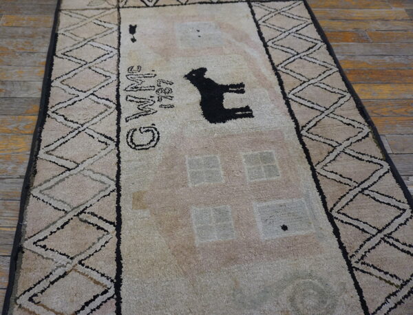 High-pile beige rug with a black animal silhouette and "wine" text on distressed wood flooring.