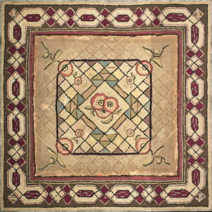 Tan square rug featuring a floral center surrounded by concentric borders with maroon and brown geometry.