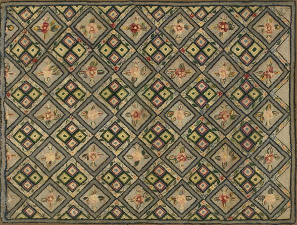 Rustic, textured rug in muted gray and earth tones, featuring alternating diamond floral and geometric designs.