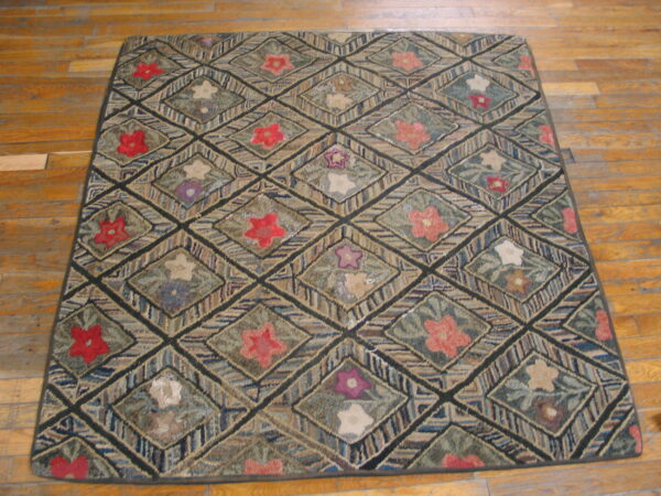 Hooked texture rug with diagonal lattice of multicolored stripes and central floral designs on wood planks.