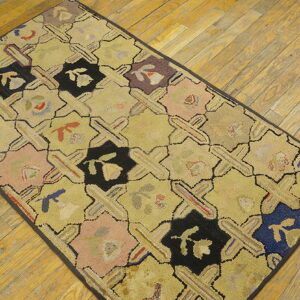 Low-pile geometric rug with yellow, black, and multicolored octagons on rustic diagonal wood flooring.