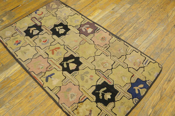 Low-pile geometric rug with yellow, black, and multicolored octagons on rustic diagonal wood flooring.