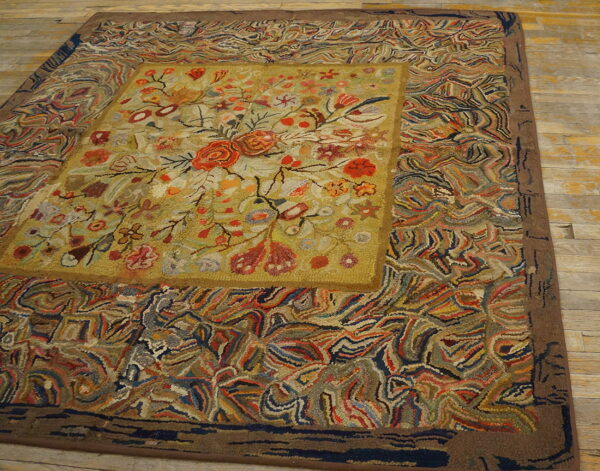 Multicolored hooked rug displaying a floral medallion and abstract swirling patterns on wood floors.