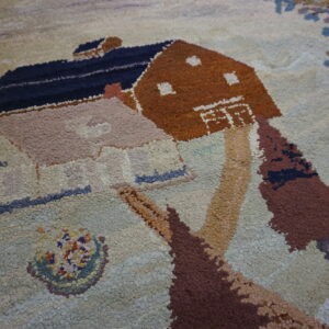 Chunky pile rug featuring a pictorial design of brown and pink houses with trees on a light background.