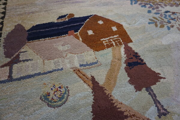 Chunky pile rug featuring a pictorial design of brown and pink houses with trees on a light background.