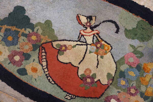 Textured rug with a scene of a woman in a red and cream dress among green foliage and multicolor flowers.