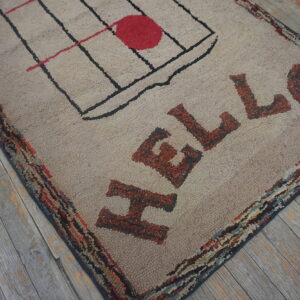 Shaggy beige rug with red HELLO lettering and grid design sits on rustic gray wood planks.