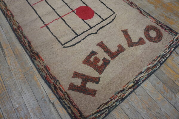 Shaggy beige rug with red hello lettering and grid design sits on rustic gray wood planks.