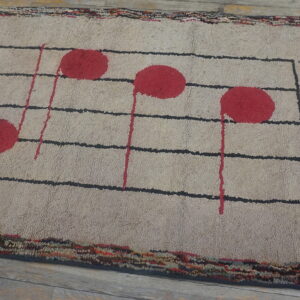 Beige textured rug displaying a black musical staff, red notes, and the word HELLO on wood floors.