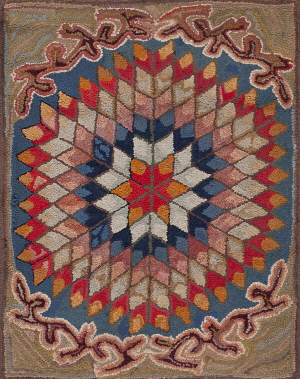 Textured rug featuring a central geometric star medallion and ornate scrolling border in blue, red, and tan.