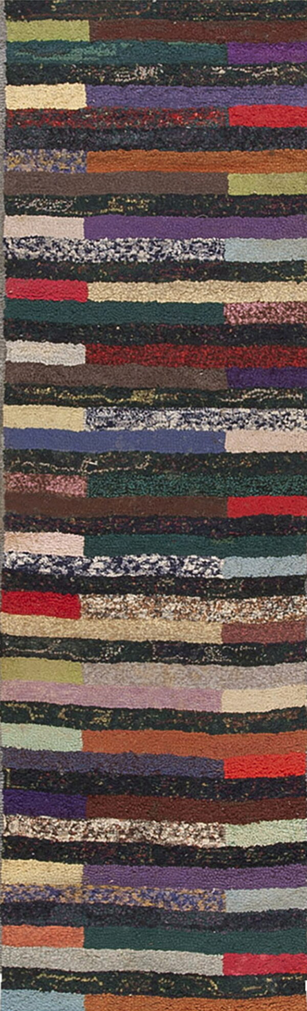 High-pile rug runner displaying a striped design made of irregular, multicolored blocks of texture.