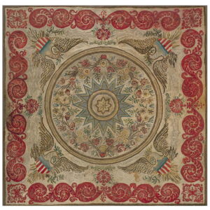 Square hooked rug featuring a central star and floral medallion, framed by red scrolling patterns and eagles.