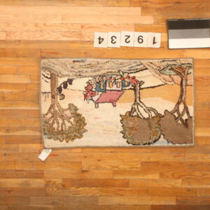 Pictorial hooked rug with trees and figures in earth tones rests on a natural plank wood floor.