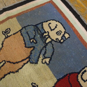 Rustic hooked rug with cartoon figures in blue, tan, and red, framed by multicolored stripes on wood floor.
