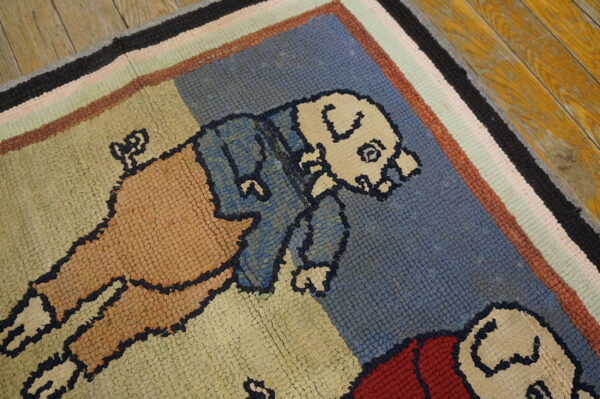 Rustic hooked rug with cartoon figures in blue, tan, and red, framed by multicolored stripes on wood floor.