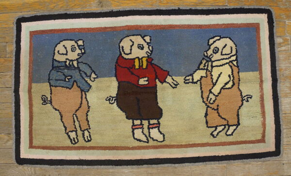 Textured rug depicting three costumed pigs on a blue and beige ground, bordered by multi-colored stripes.