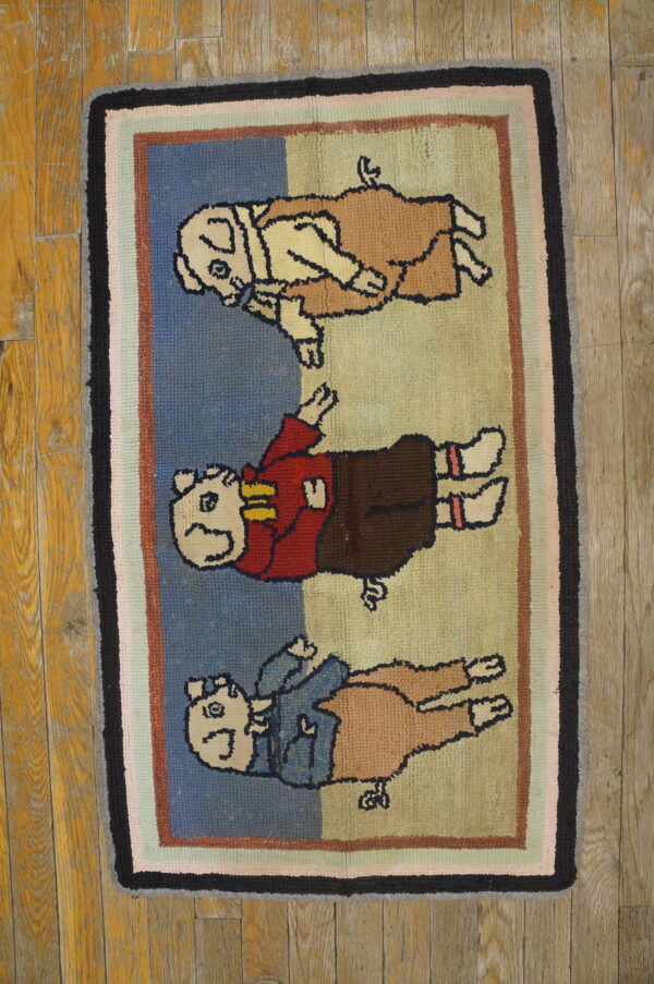 Hooked novelty rug features three cartoon animals in colorful clothing with a multicolored striped border on wood flooring.
