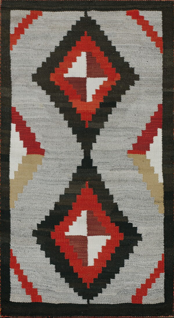 Flatwoven rug with gray field and bold stepped diamonds in red, black, white, and tan colors.
