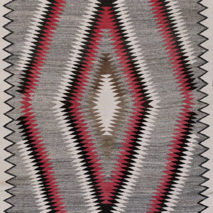 Low profile rug featuring a large serrated diamond design in red, black, and white on a heathered gray field.