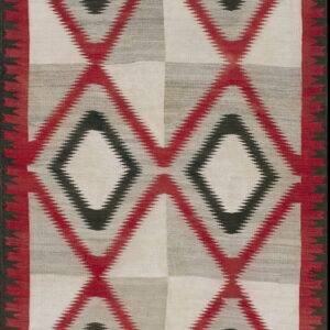 White, gray, red, and black flat-weave rug featuring large serrated diamond and zigzag designs.