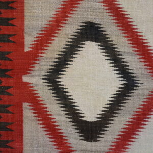 Flatweave rug with a nested diamond pattern using red, black, cream, and gray colors.