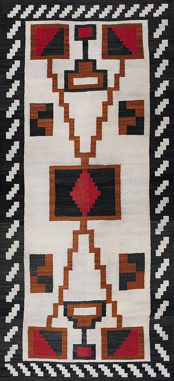 Vertical flatweave rug featuring geometric black, white, red, and brown stepped designs throughout the field.