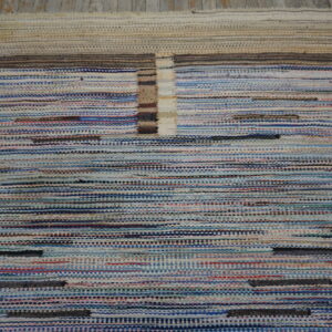 Variegated flatweave rug with horizontal blue and white stripes bordered by beige and brown accents.