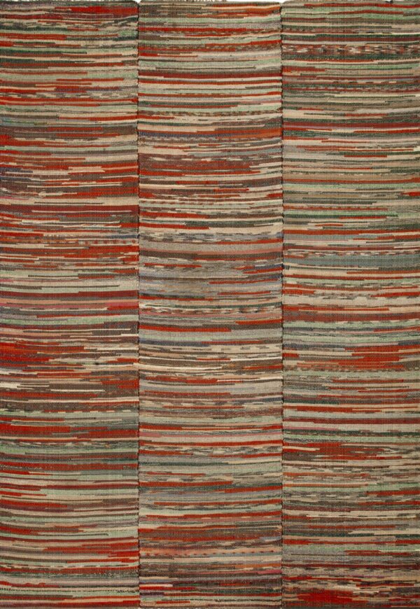 A textured, flat-woven rug with vertical multicolored stripes of red, blue, gray, and brown strips on wood.