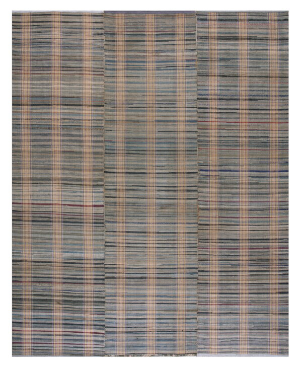 Flatweave rug in variegated gray, tan, and blue stripes forming a subtle plaid design across three panels.