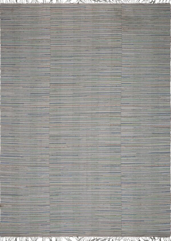 Cream flatweave rug featuring subtle vertical multicolored stripes lying on worn plank wood flooring.