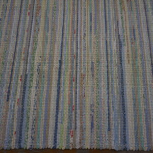 Multicolor flatweave rug with thin vertical stripes resting on a dark brown wooden floor.