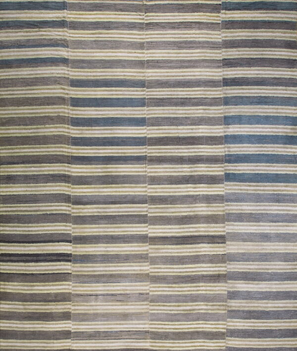 The rug displays horizontal stripes and joined vertical panels in shades of gray, slate blue, and pale green.