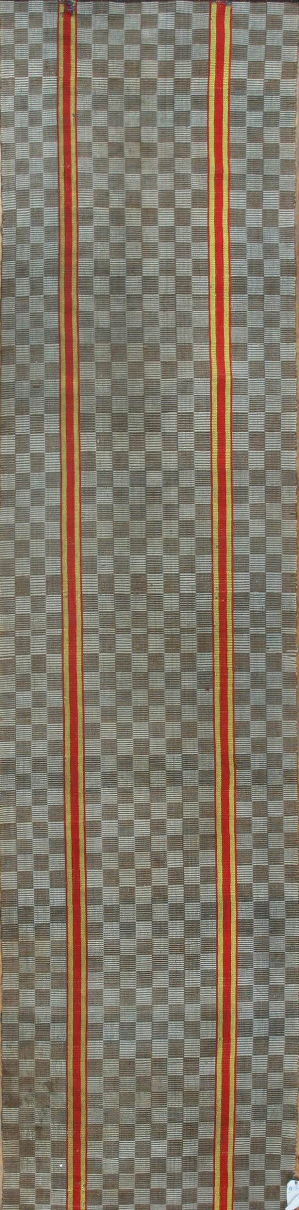 Flatweave runner displaying a gray checkerboard and two vertical red stripes framed by yellow bands.