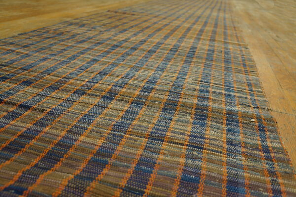 Vintage american rag rug hallway runner multicolor 1950s 4 Flatwoven american rag rug runner in mixed blue, tan, and orange plaid texture on wide plank wood flooring.