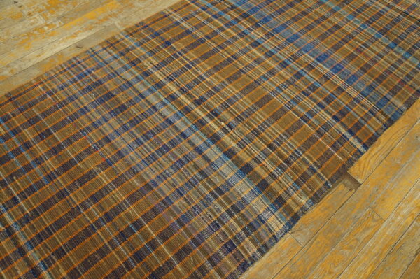Vintage american rag rug hallway runner multicolor 1950s 9 Flatwoven plaid runner rug in brown, blue, and orange on distressed yellow wooden planks.
