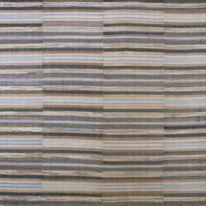 Flatweave rug with neutral, horizontal stripes of gray, taupe, blue, and brown across stitched vertical panels.