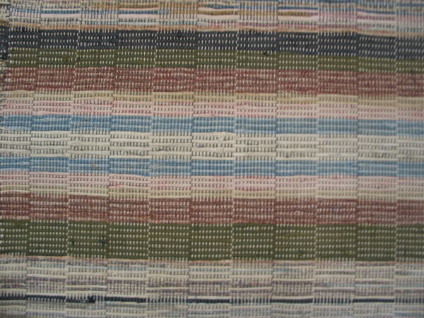Tightly woven, low-pile rug featuring horizontal stripes in muted blue, green, pink, and brown tones.