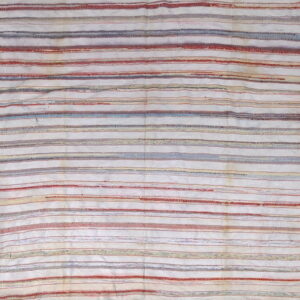Flatweave rug featuring textured horizontal stripes in off-white, muted red, blue, and tan.