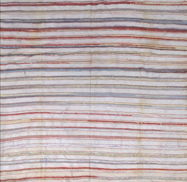 Flatweave rug featuring textured horizontal stripes in off-white, muted red, blue, and tan.