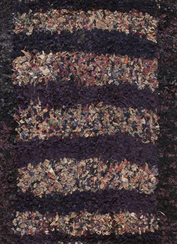 Textured close-up showing dark purple vertical stripes interspersed with multicolored, high-pile fabric pieces.